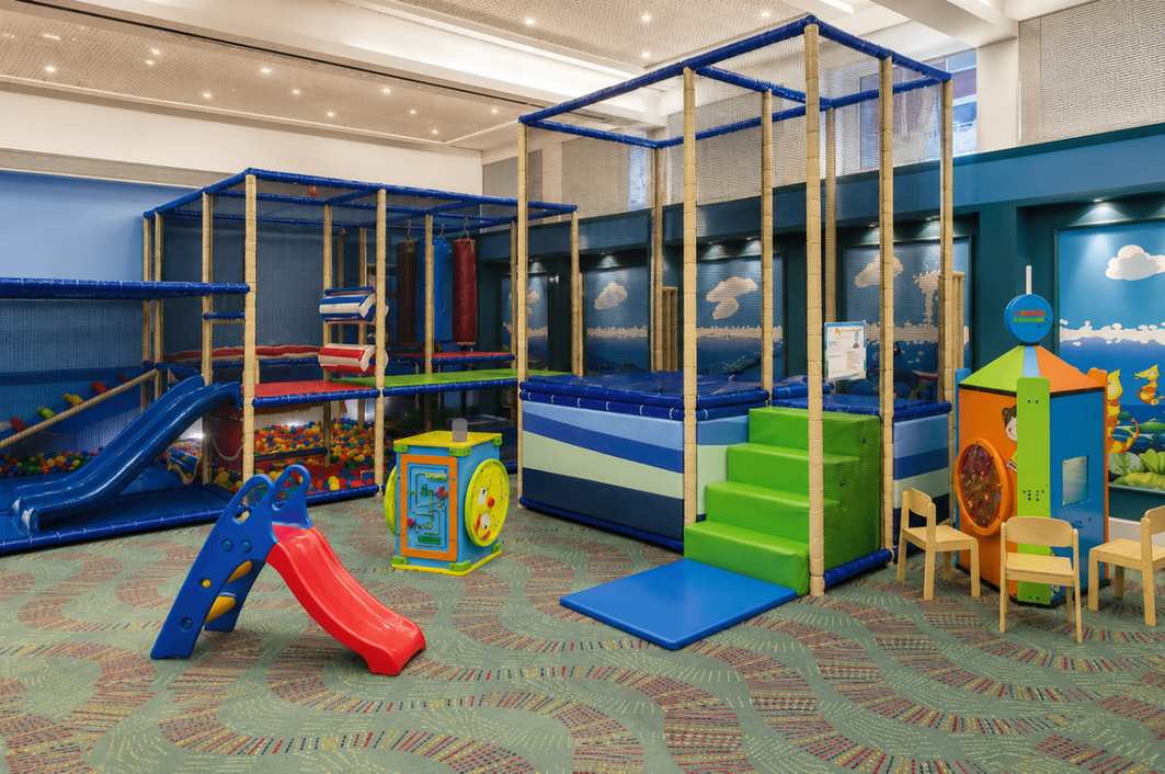 Indoor kids club play area with slides and soft play equipment